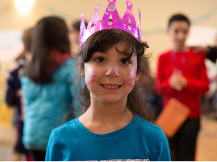 girl wearing paper crown and face paint